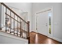 Bright foyer features hardwood floors, staircase with wood and iron railing, and natural light at 200 Glen Wood Place, Canton, GA 30114