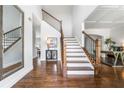 Elegant foyer boasts hardwood floors, a staircase with iron railing, and access to multiple rooms at 200 Glen Wood Place, Canton, GA 30114
