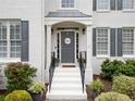 Inviting front door with a welcoming wreath, flanked by manicured landscaping and elegant railings at 200 Glen Wood Place, Canton, GA 30114