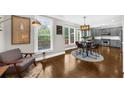 Cozy living area with hardwood floors, large windows, a modern light fixture, and an adjacent kitchen at 2653 W Main Nw St, Atlanta, GA 30318