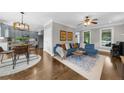 Open-concept living space featuring a cozy blue sectional and hardwood floors throughout at 2653 W Main Nw St, Atlanta, GA 30318