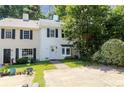 Well-manicured lawn with sidewalk leading up to this townhouse with mature landscaping, and a white front door at 289 Westland Sw Way, Marietta, GA 30064