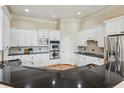 Modern kitchen features white cabinets, stainless steel appliances, and granite countertops at 4046 Newhaven Ne Cir, Atlanta, GA 30319