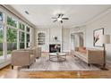 Bright living room with hardwood floors, large windows, and a fireplace at 4046 Newhaven Ne Cir, Atlanta, GA 30319