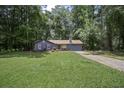 Charming single-story home with blue siding, red shutters, and a lush green lawn at 539 Karen Dr, Alpharetta, GA 30009
