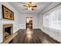 Spacious living room featuring a fireplace, dark wood floors, and an abundance of natural light at 1747 Parkhill Dr, Decatur, GA 30032