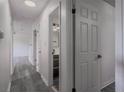 Hallway with hardwood floors and white doors leading to various rooms at 3570 Briar Dr, Lithia Springs, GA 30122