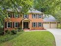 Beautiful brick home with black shutters and a well-manicured lawn at 1863 Wicks Valley Ne Dr, Marietta, GA 30062