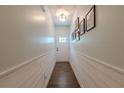 Bright hallway with shiplap accent and views of the front door at 3291 Wild Basil Ln, Buford, GA 30519