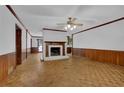 Bright living room featuring a brick fireplace and classic hardwood floors at 6896 Heardsville Rd, Cumming, GA 30028
