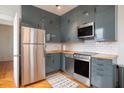 Modern kitchen with stainless steel appliances, gray cabinets, and wood countertops at 75 Ponce De Leon Ne Ave # 1004, Atlanta, GA 30308
