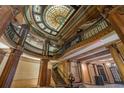 Elegant lobby with stained glass ceiling, ornate columns, and a grand staircase at 75 Ponce De Leon Ne Ave # 1004, Atlanta, GA 30308