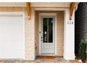 Close-up of the front door, showcasing the stone facade, wooden accents, and a 'welcome home' door mat at 114 Batten Board Way, Woodstock, GA 30189