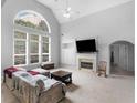 Bright living room with cathedral ceiling, large arched window and fireplace at 1613 Brolington Ct, Conyers, GA 30013