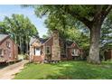 Beautiful brick home with stone details, mature trees, and a well-manicured front lawn at 311 Glendale Ave, Decatur, GA 30030
