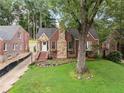 Brick home featuring a stone chimney and walkway, complemented by a well-maintained lawn at 311 Glendale Ave, Decatur, GA 30030