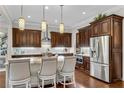 Modern kitchen featuring custom cabinetry, granite countertops, stainless steel appliances, and pendant lighting at 3663 Brookhaven Manor Crossing Ne, Atlanta, GA 30319
