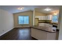 Eat-in kitchen features white cabinetry and a breakfast bar overlooking the living area at 3646 Salem Dr, Lithonia, GA 30038