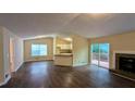 Open-concept living room with dark wood floors, a fireplace, and a view of the kitchen at 3646 Salem Dr, Lithonia, GA 30038