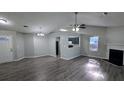 Spacious living room with hardwood floors, fireplace, modern lighting, and open kitchen view at 1513 Foxhall Se Ln, Atlanta, GA 30316