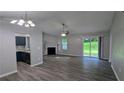 Open living area with sliding glass doors, a fireplace, and an open view of the modern kitchen at 1513 Foxhall Se Ln, Atlanta, GA 30316