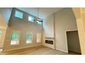 A stunning living room boasts high ceilings, large windows, modern fireplace, and natural light at 4850 Cool Springs Rd, Winston, GA 30187