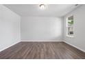 A room featuring wood-look floors, white walls and trim, as well as a window at 6934 Melody Ridge Rd, Buford, GA 30518