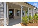 Close-up of front porch showcasing brick accents and craftsman-style columns at 6934 Melody Ridge Rd, Buford, GA 30518