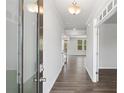 Bright hallway with modern wood flooring and crisp white walls, leading to other rooms at 6934 Melody Ridge Rd, Buford, GA 30518