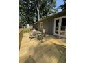 Outdoor wooden deck featuring a dining table set, ideal for outdoor entertaining and relaxation at 205 Trickum Hills Ln, Woodstock, GA 30188