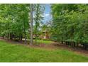 Beautiful red brick home with manicured front lawn and mature trees adding privacy and curb appeal at 240 Old Plantation Way, Fayetteville, GA 30214