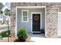 Inviting front entry with brickwork and black front door with wreath at 3554 Bluebird Ct, Atlanta, GA 30331