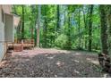 Spacious backyard with vibrant green trees and woodpile at 5215 Mainstreet Park Dr, Stone Mountain, GA 30088