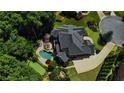An aerial view of a large home highlighting the backyard swimming pool, putting green, and manicured grounds at 217 Fernwood Pl, Woodstock, GA 30188