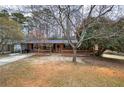 Traditional brick home with inviting front porch and mature trees at 4225 Parkridge Dr, Powder Springs, GA 30127