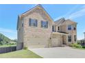 Brick home featuring a three-car garage and a neatly landscaped lawn, perfect for families at 932 Melville Dr, Stockbridge, GA 30281