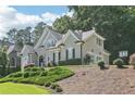 Well-maintained home with mature trees, featuring a basketball hoop and neatly trimmed greenery at 4472 Cavallon Nw Way, Acworth, GA 30101