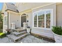 Inviting front entrance with stone steps, decorative plants, and a charming front door at 4472 Cavallon Nw Way, Acworth, GA 30101