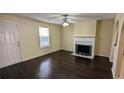 Inviting living room featuring a fireplace, ceiling fan, and hardwood floors at 4707 Golod Way, Lithonia, GA 30038