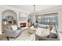 Cozy living room with fireplace, plush seating, and a seamless transition to an outdoor deck at 125 Maison Court, Roswell, GA 30076