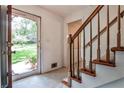 Inviting foyer featuring a staircase with wooden banister, light-colored walls, and views of the front yard at 1338 Talcott Pl, Decatur, GA 30033