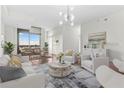 Bright living space with floor-to-ceiling windows and views, modern decor and hardwood floors at 270 17Th Nw St # 4306, Atlanta, GA 30363