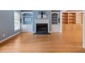 Bright living room with hardwood floors, a fireplace, and custom built-in shelving at 1355 E Rock Springs Ne Rd, Atlanta, GA 30306