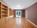 Spacious room with wood floors, custom built-ins, and french doors to the backyard at 1355 E Rock Springs Ne Rd, Atlanta, GA 30306