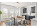 Elegant dining area with modern lighting, a built-in wine cooler, and bright natural light at 1995 Bryant Park Ln, Decatur, GA 30033