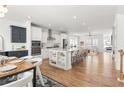 Open-concept kitchen featuring a large island, stainless steel appliances, and hardwood floors at 1995 Bryant Park Ln, Decatur, GA 30033