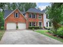 Brick home with a two car garage and manicured lawn at 2206 Heritage Trace Dr, Marietta, GA 30062