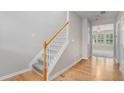View of the entryway showcasing hardwood floors, staircase, and a glimpse into the living room at 2731 Pierce Brennen Ct, Lawrenceville, GA 30043