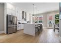 Modern kitchen boasting stainless steel appliances, an island with seating, and white cabinets at 671 Brennan Dr, Decatur, GA 30033