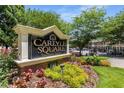 Carlyle Square condominium community signage with colorful flower beds and beautiful landscaping at 1101 Collier Nw Rd # P2, Atlanta, GA 30318